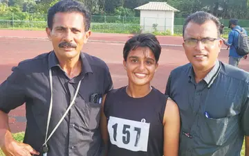 Maria Manojlal, who won gold in triathlon at the district junior athletic meet, with her father, Olympian Manojlal, and their sports guru, Dr. Thankachan Mathew.
