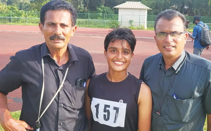 Maria Manojlal, who won gold in triathlon at the district junior athletic meet, with her father, Olympian Manojlal, and their sports guru, Dr. Thankachan Mathew.