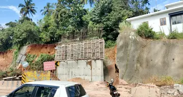 Three houses at risk after retaining wall collapses.