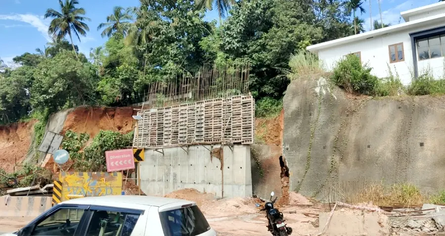 Three houses at risk after retaining wall collapses.
