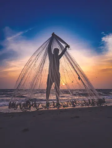 വലയൊരുക്കം... കടലിലേക്ക് വലയെറിയുന്നതിന് മുന്നോടിയായി വല വിടർത്തി പരിശോധിക്കുന്ന മത്സ്യത്തൊഴിലാളി.  ആലപ്പുഴ ബീച്ചിൽനിന്നാണ് ദൃശ്യം                                                                                                    ഫോട്ടോ : ജിഷ്ണു പൊന്നപ്പൻ 