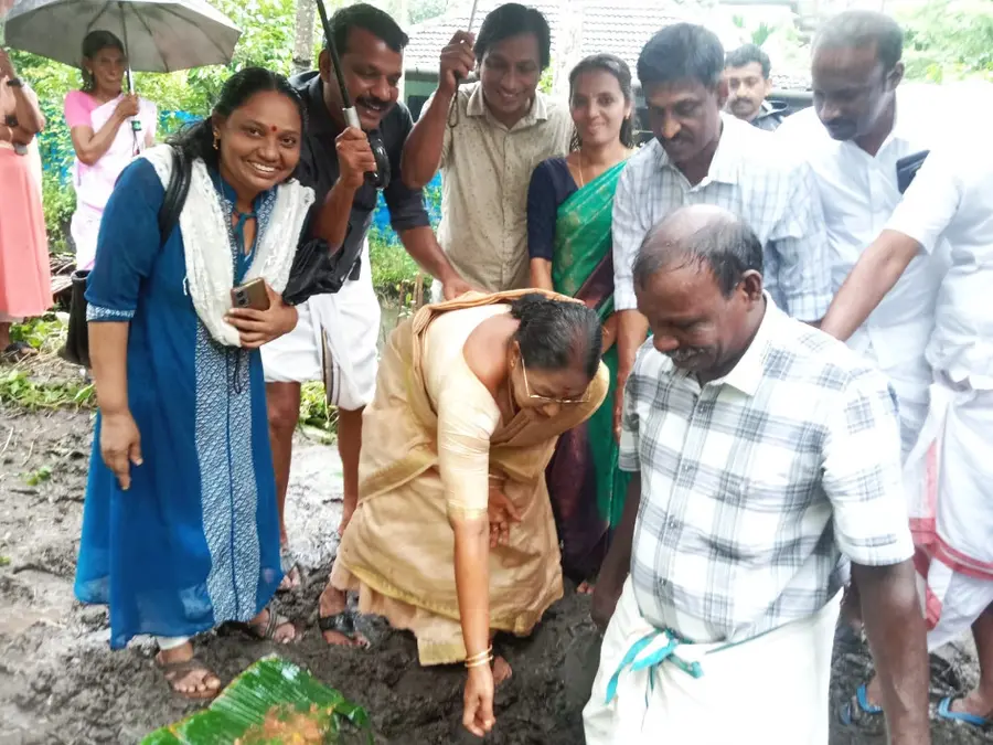 Chairperson Shirley Bhargavan lays the foundation stone for a house being built on land purchased for four landless and homeless beneficiaries of the Cherthala Municipality Extreme Poverty Alleviation Project.