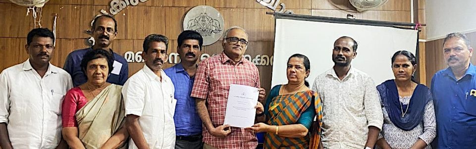 Block Panchayat President Jinsi Jolly hands over the roadmap to Finance Commission Chairman Dr. K. N. Harilal
