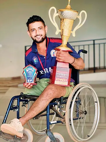Vinosh with the trophy she won playing
