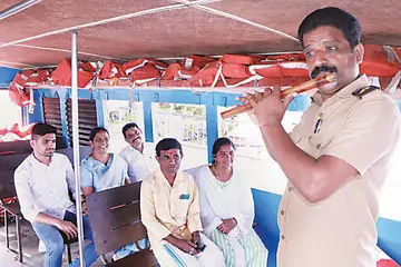 Muhamma–- Laskar R Sandeep plays the flute on a passenger boat on the Kumarakom ferry