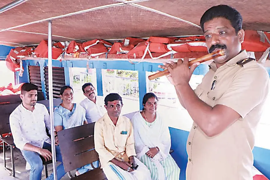 Muhamma–- Laskar R Sandeep plays the flute on a passenger boat on the Kumarakom ferry