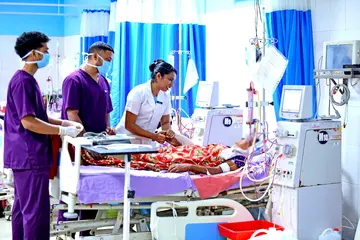 Dialysis in-charge nurse D Asha inquires about the patient's condition in the dialysis unit at Alappuzha General Hospital.