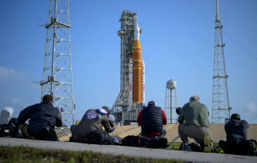NASA Artemis II crew and SLS rocket"