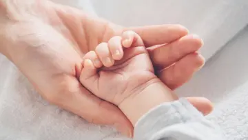 baby girl  in  mothers cradle
