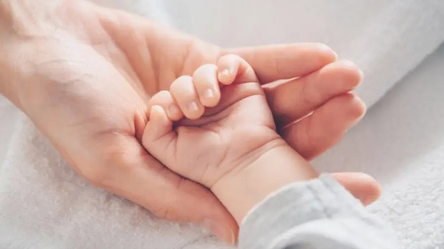 baby girl in mothers cradle