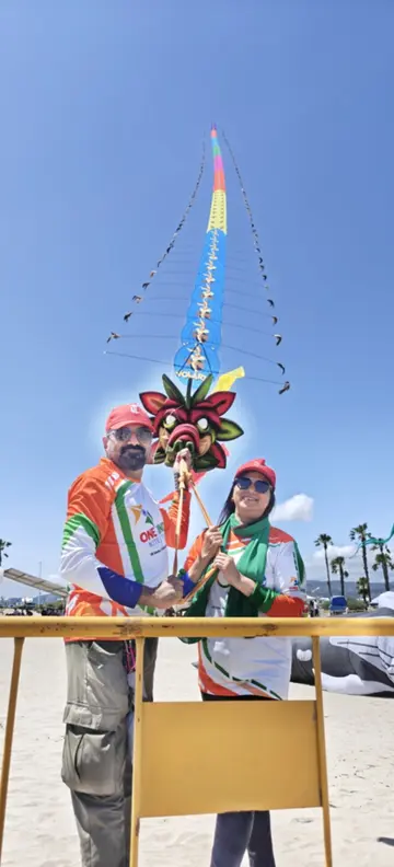 Beneath the kites, a couple from Malappuram stands with the severed ends of the strings.