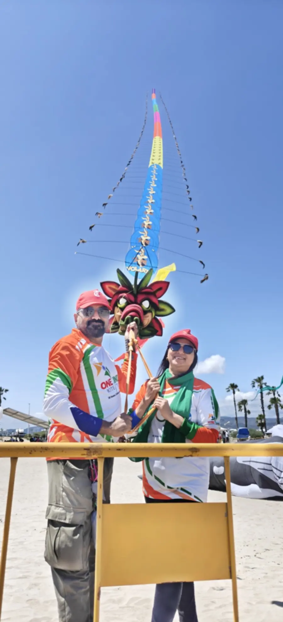 Beneath the kites, a couple from Malappuram stands with the severed ends of the strings.
