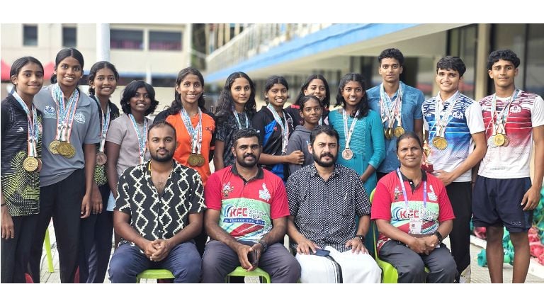 നീന്തലിൽ മെഡൽ നേടിയവർ കോച്ച് ലിജുവിനും സ്വിമ്മിങ് അഡ്മിനിസ്ട്രേറ്റർ കെ എസ് ഷാജുവിനുമൊപ്പം